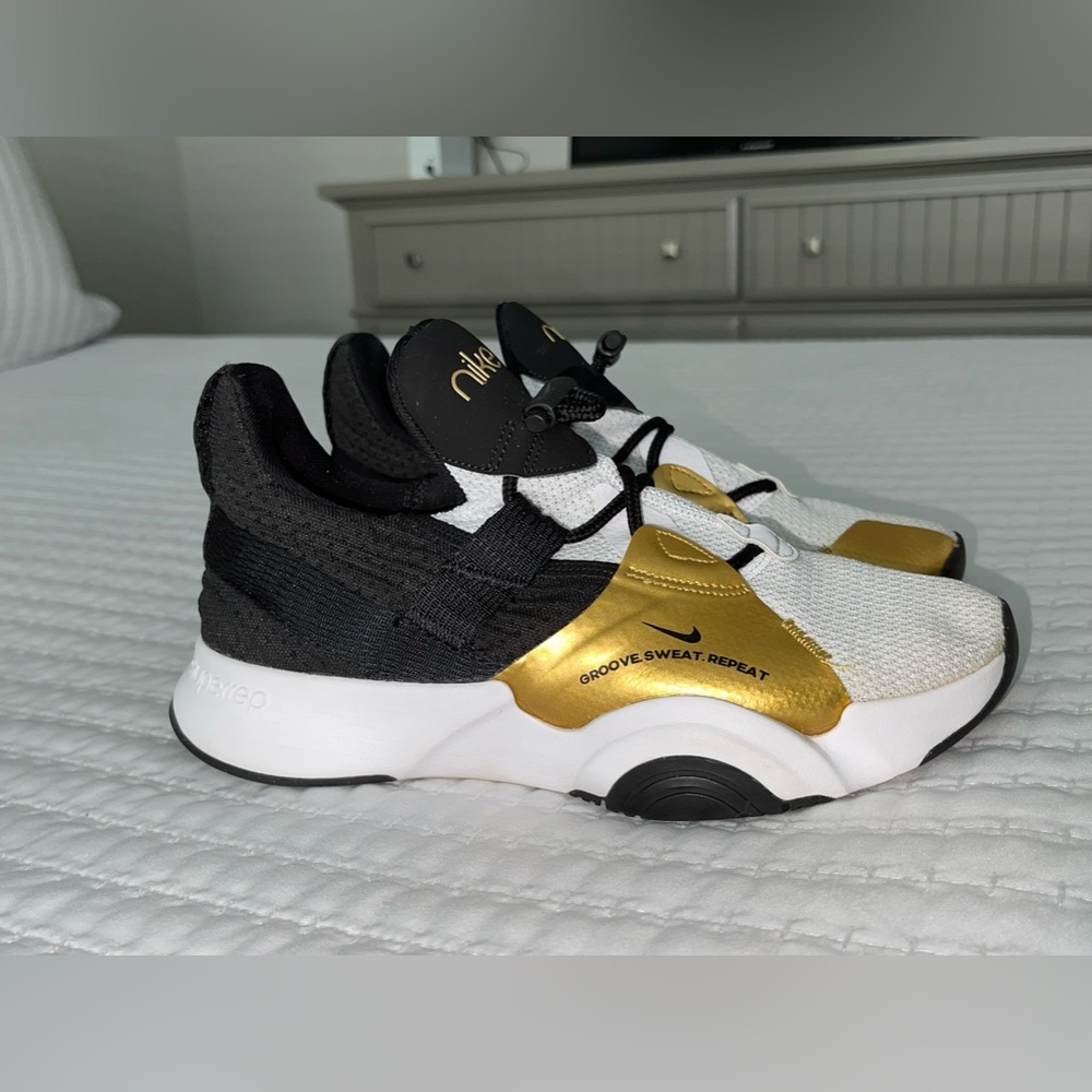Nike sneakers size 6 gold black white womans